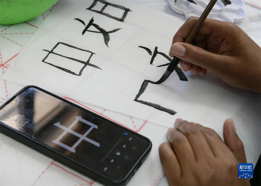 4月18日，肯尼亞學(xué)生在內(nèi)羅畢大學(xué)孔子學(xué)院舉辦的活動上寫毛筆字?？夏醽唭?nèi)羅畢大學(xué)孔子學(xué)院18日舉辦“中文，增進(jìn)文明對話”主題活動，慶祝即將到來的第14個聯(lián)合國中文日。肯尼亞學(xué)生參與互動，進(jìn)行書法、剪紙、唱中文歌等活動。新華社記者 韓旭 攝