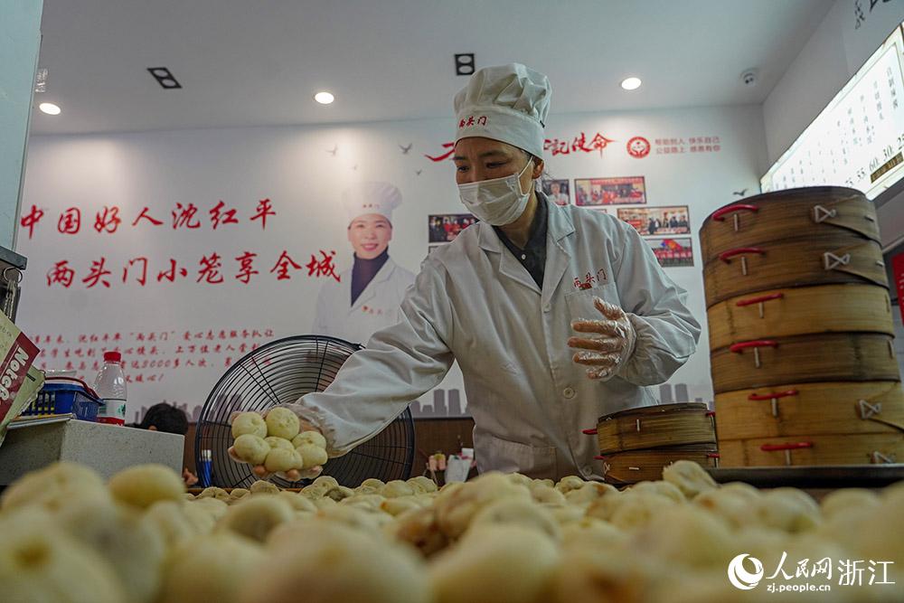 3月31日，在浙江省嵊州市甘霖鎮(zhèn)，嵊州小吃從業(yè)者沈紅平把蒸熟的小籠包晾涼，打包冷藏售賣。人民網 章勇濤攝