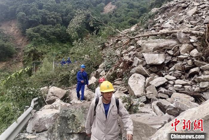 電力搶險(xiǎn)人員徒步通過(guò)垮塌路段?！∷拇娏﹫D