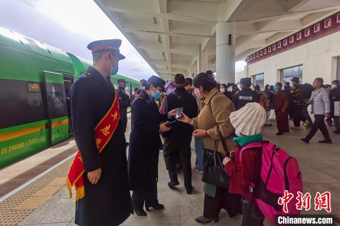 日喀則火車站工作人員引導(dǎo)乘客乘坐高原復(fù)興號(hào)。　斗山得 攝
